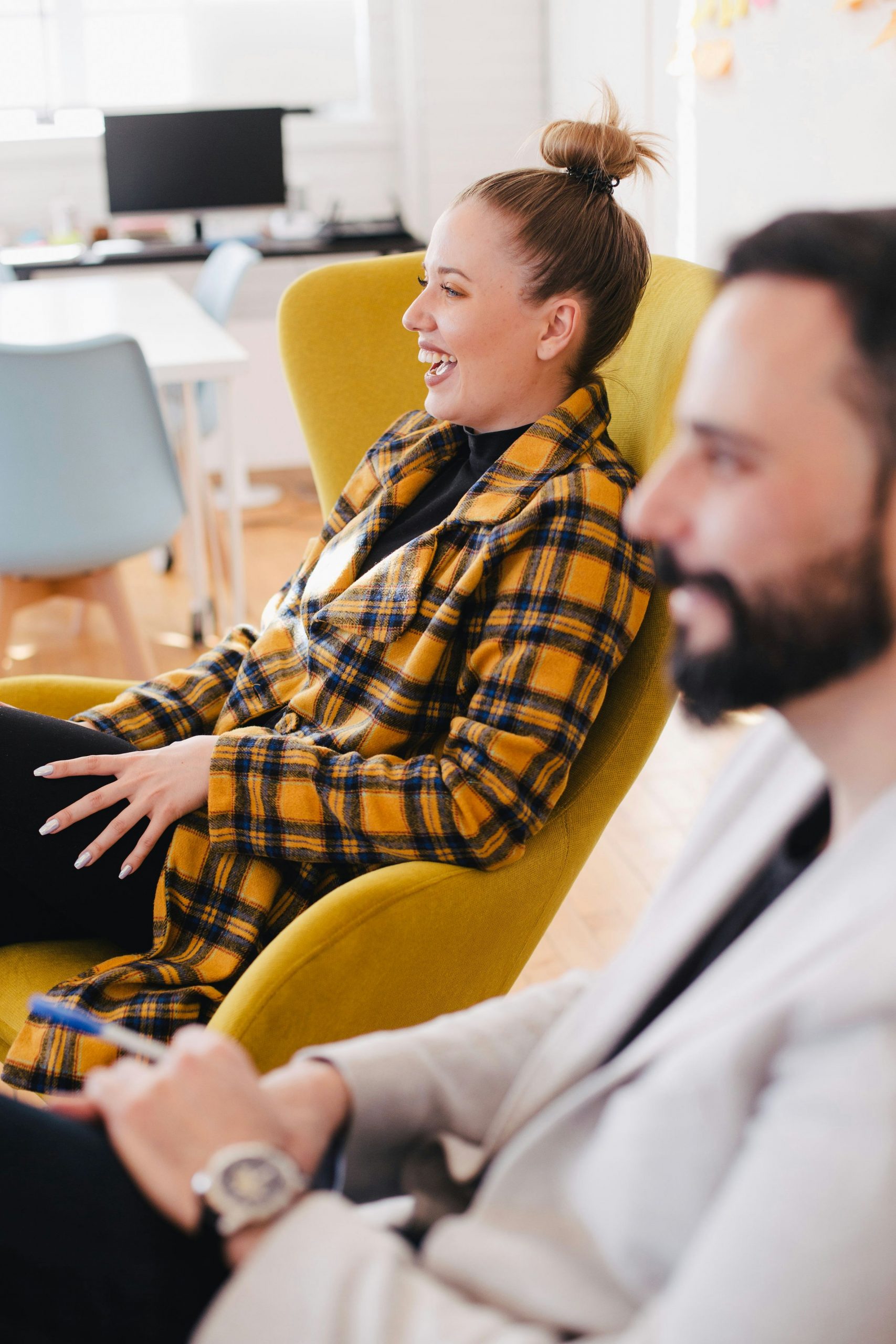 Woman smiling with black and orange shirt - Business Services & Leadership Consultancy